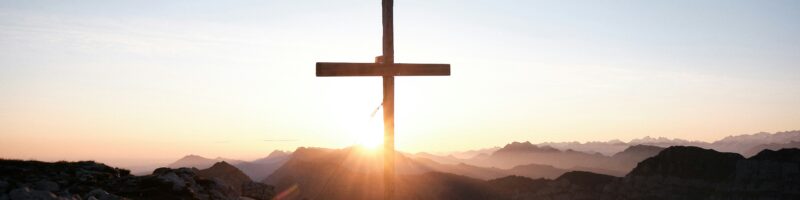 brown cross on brown rock during daytime