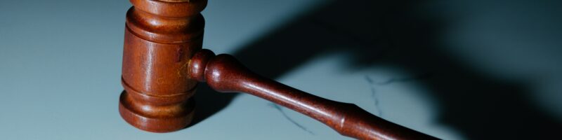 a wooden judge's hammer sitting on top of a table