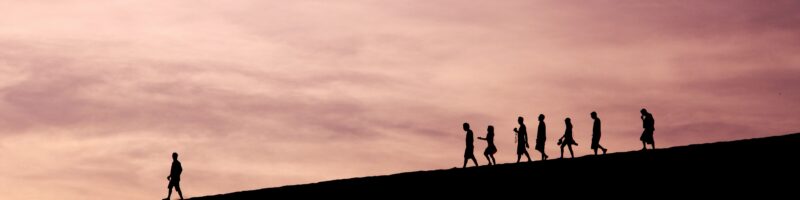 silhouette of people on hill