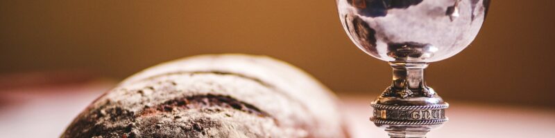 gray footed cup beside baguette bread