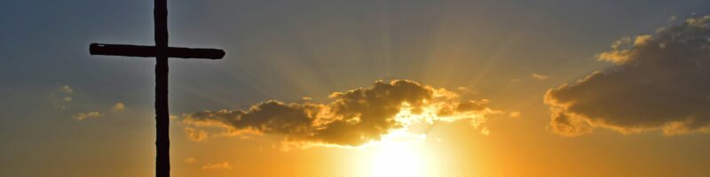 silhouette of cross during sunset