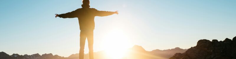 person standing on hill