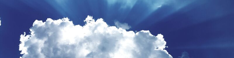 sun rays through white cumulus clouds