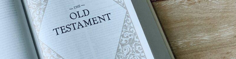 an open book with the words old testament on it