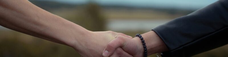 Two people shake hands in a symbolic gesture.