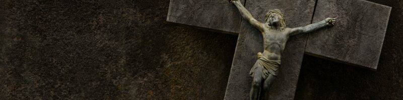 a statue of jesus on a cross on a wall